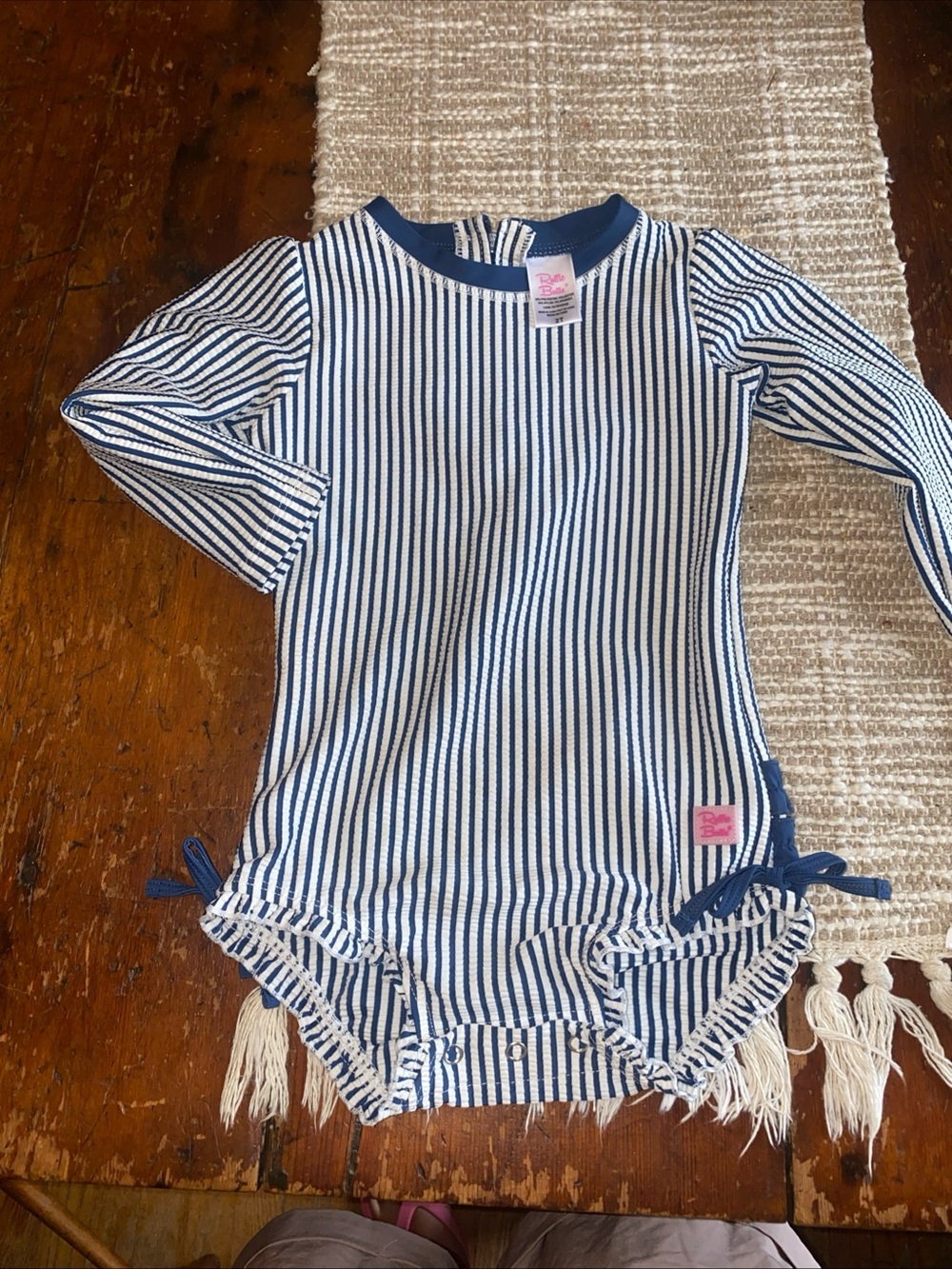 Ruffle Butts Navy & White Striped Baby swimsuit with Pink Logo